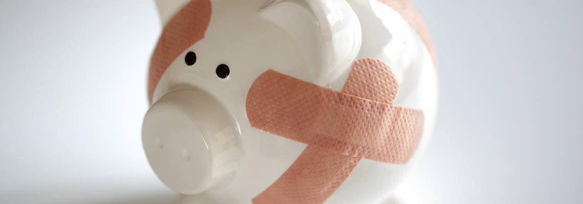 piggy bank with plasters on