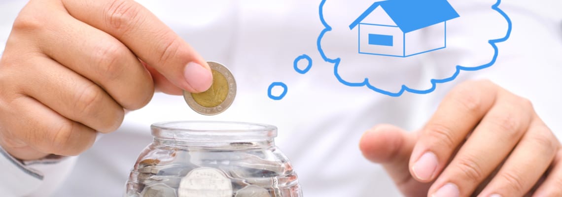 putting coins in jar thinking of houses