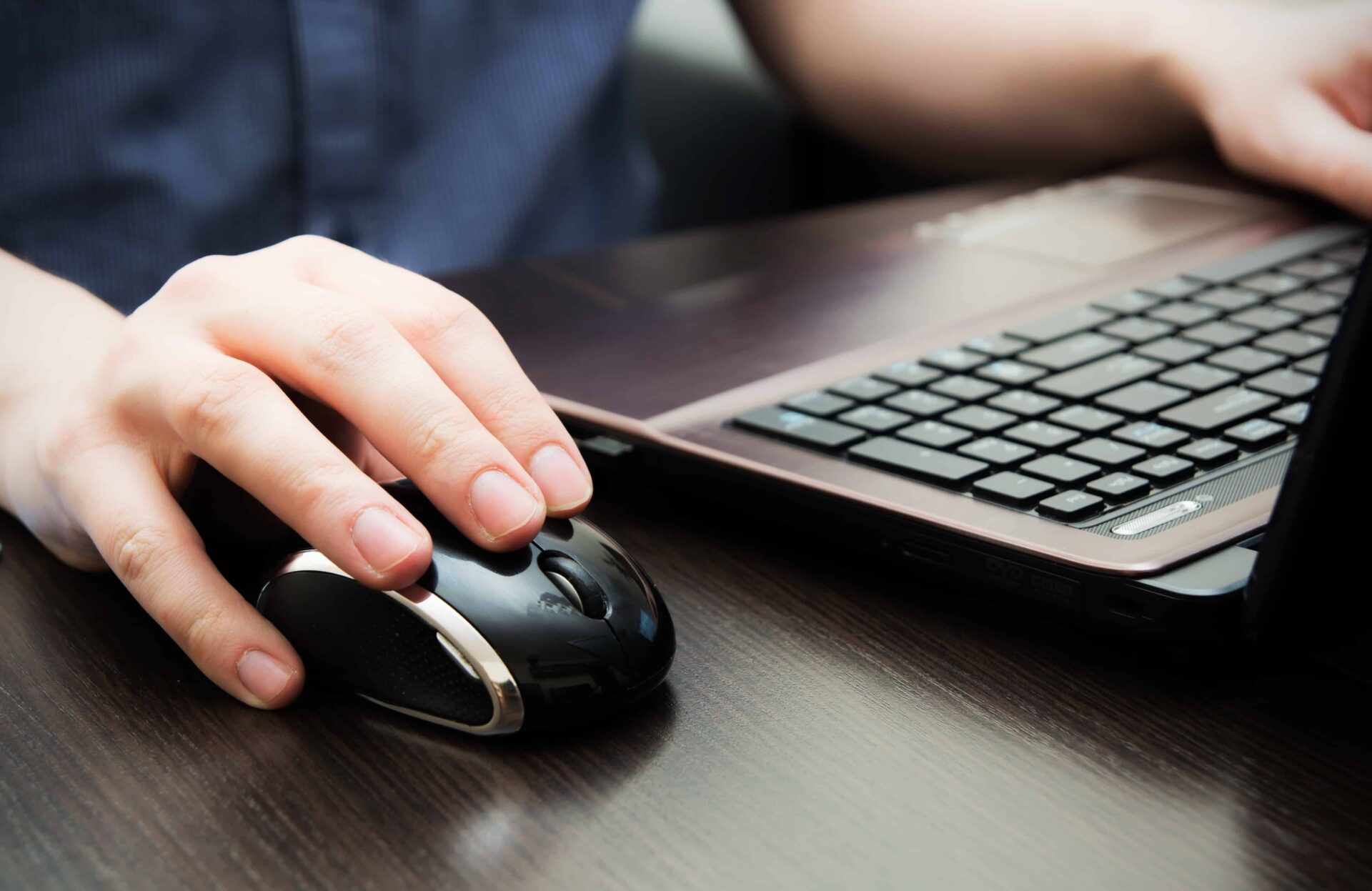 human hand on computer mouse