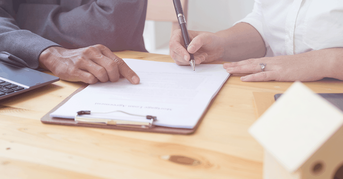 couple signing document together