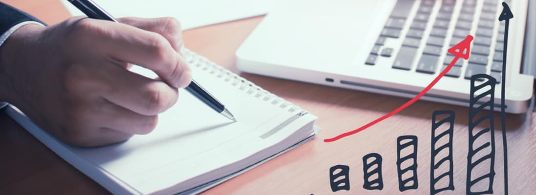 man writing in notepad