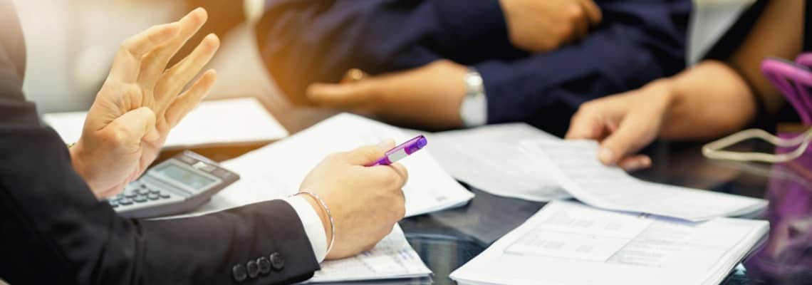 three people in a meeting