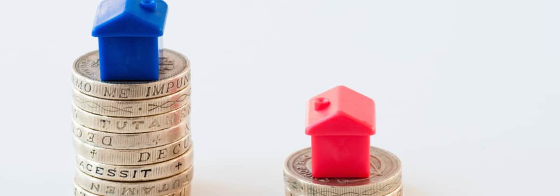 toy houses on top of piles of money