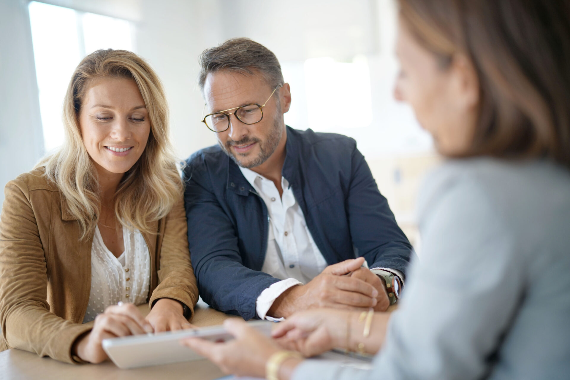 Mature couple meeting real-estate agent in office