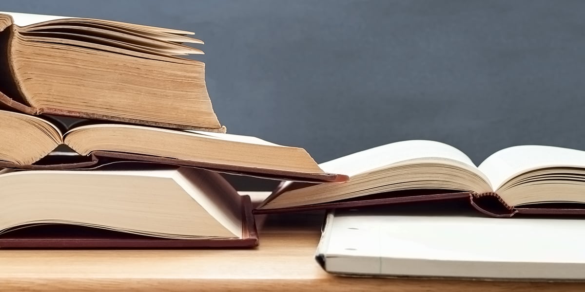 pile of books on a desk