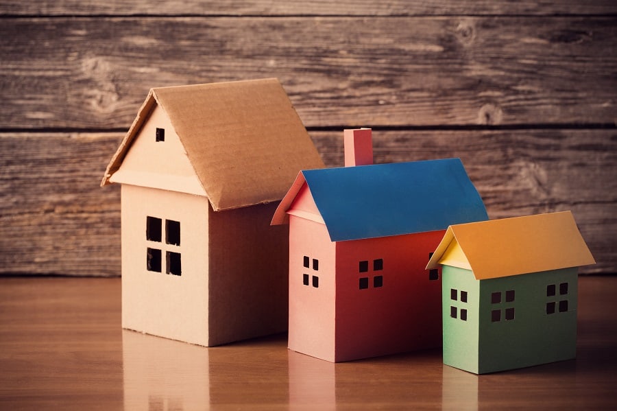 paper houses on wooden background